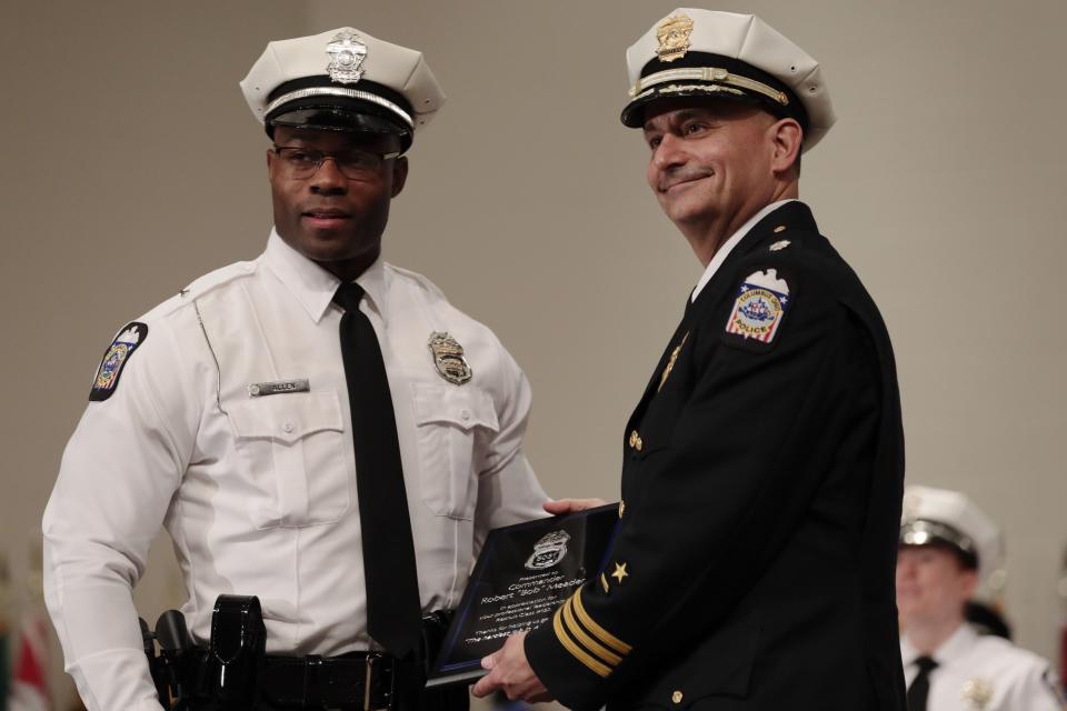 Then-Columbus Police Commander Robert Meader, right, on Jan. 3, 2020, with Officer Alexander Allen after being presented with an award  during the Columbus Police Academy 132nd recruit class graduation.