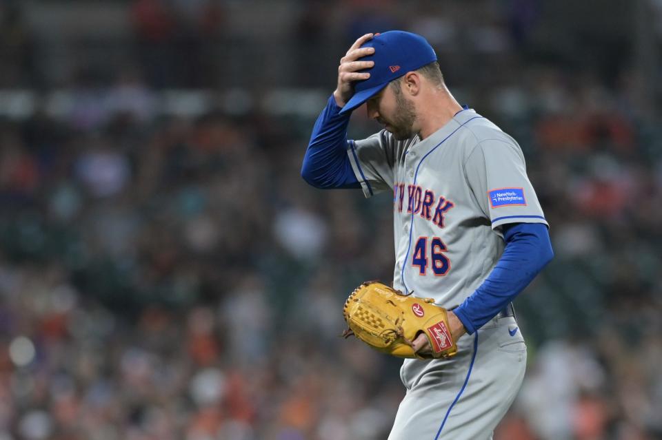 Aug 4, 2023; Baltimore, Maryland, USA; New York Mets relief pitcher John Curtiss (46) adjust his hat while walking to the pitcher's mound during the game against the Baltimore Orioles  at Oriole Park at Camden Yards.