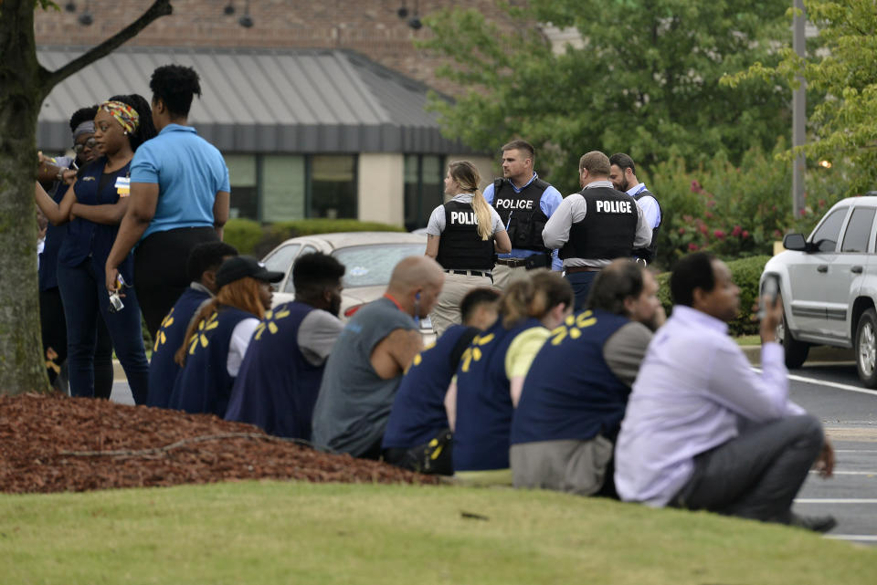Officers and employees gather in a nearby parking lot after a shooting at a Walmart store Tuesday, July 30, 2019 in Southaven, Miss. (AP Photo/Brandon Dill)