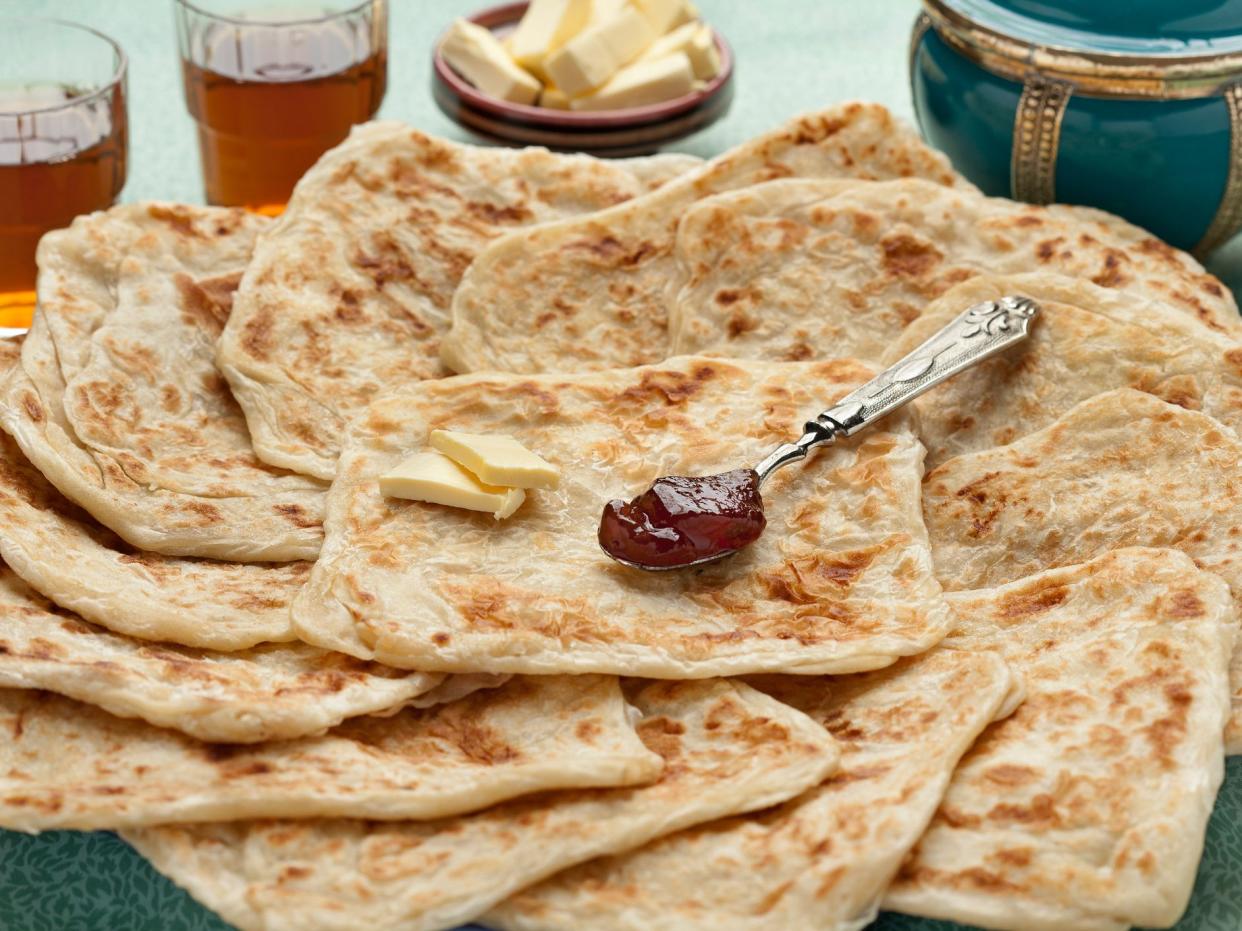 Fresh baked Moroccan square pancakes called Rghaif or Msemen with butter and jam