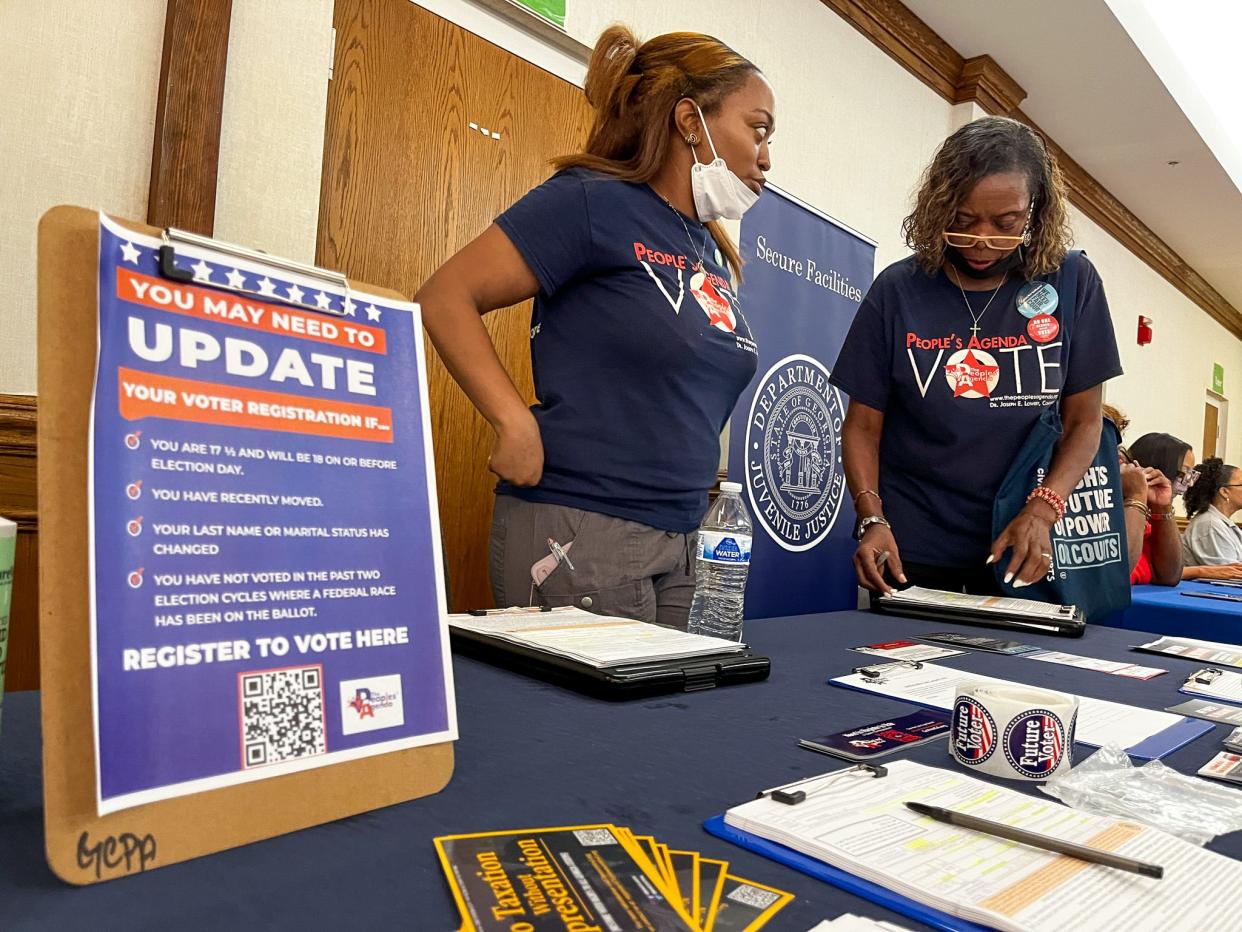 Diona Holman 27, and Linda Watson, 73, voting rights advocates for the Georgia Coalition for the People’s Agenda, worked to update voter registrations for people they met at a job fair in Tucker, Georgia, just east of Atlanta.