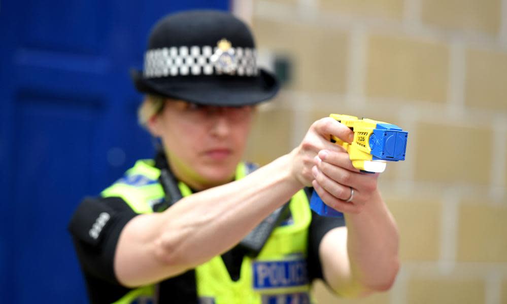 A police officer fires a Taser