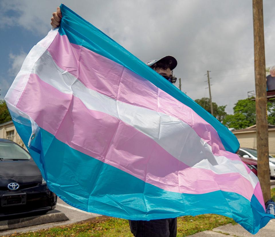 A demonstrator holds a flag at a rally supporting transgender youth in Lady Lake on Sunday, April 25, 2021. [PAUL RYAN / CORRESPONDENT]