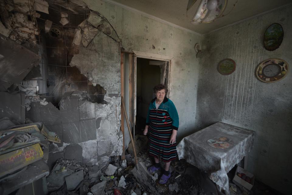 A woman stands among the rubble in her damaged apartment hit by recent shelling, what local officials called a Ukrainian military strike, in Donetsk, Russian-controlled Ukraine (AFP via Getty Images)