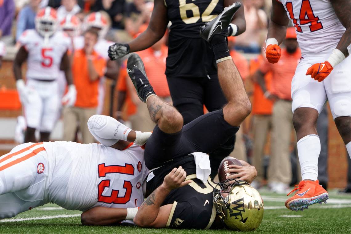 Wake Forest quarterback Sam Hartman (10) is sacked by Clemson defensive tackle Tyler Davis (13) during the first half of an NCAA college football game in Winston-Salem, N.C., Saturday, Sept. 24, 2022.