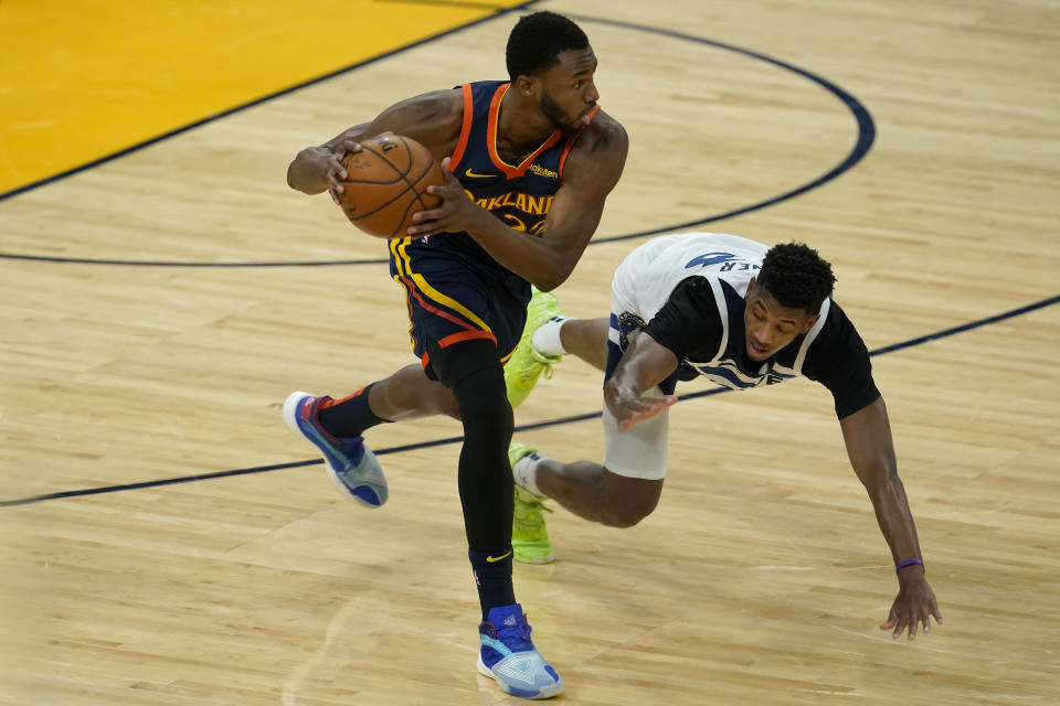 Golden State Warriors forward Andrew Wiggins, left, grabs the ball in front of Minnesota Timberwolves guard Jarrett Culver during the first half of an NBA basketball game in San Francisco, Monday, Jan. 25, 2021. (AP Photo/Jeff Chiu)