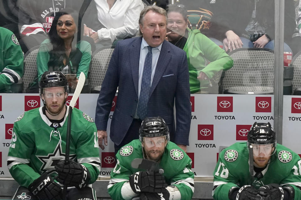 Dallas Stars coach Rick Bowness, top, yells from the bench behind Radek Faksa (12), Luke Glendening (11) and Michael Raffl (18) during the second period of the team's NHL hockey game against the Arizona Coyotes in Dallas, Wednesday, April 27, 2022. (AP Photo/LM Otero)