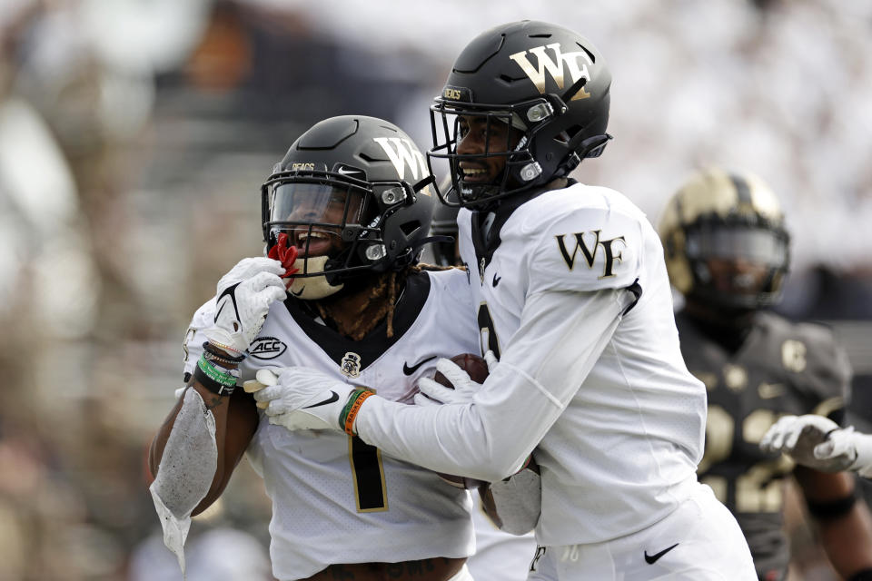 Wake Forest running back Christian Beal-Smith (1) reacts with A.T. Perry after scoring a touchdown against Army during the first half of an NCAA college football game Saturday, Oct. 23, 2021, in West Point, N.Y. (AP Photo/Adam Hunger)