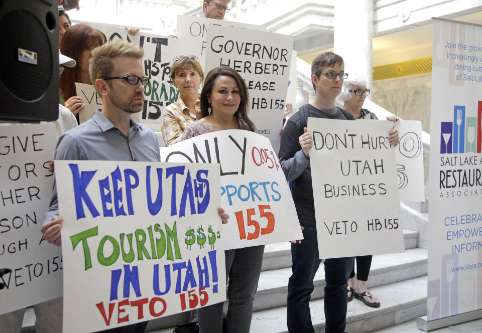 FILE - In this March 17, 2017, file photo, protesters holds signs during rally concerning the DUI threshold at the Utah state Capitol in Salt Lake City. New Year's Eve revelers in Utah may find themselves with more than a hangover as 2019 dawns: If they drink and drive, they could get hit by the newest and lowest DUI threshold in the nation. The .05 percent limit goes into effect Dec. 30, despite protests that it will punish responsible drinkers, hurt the state's tourism industry and amplify its alcohol-unfriendly reputation. (AP Photo/Rick Bowmer, File)