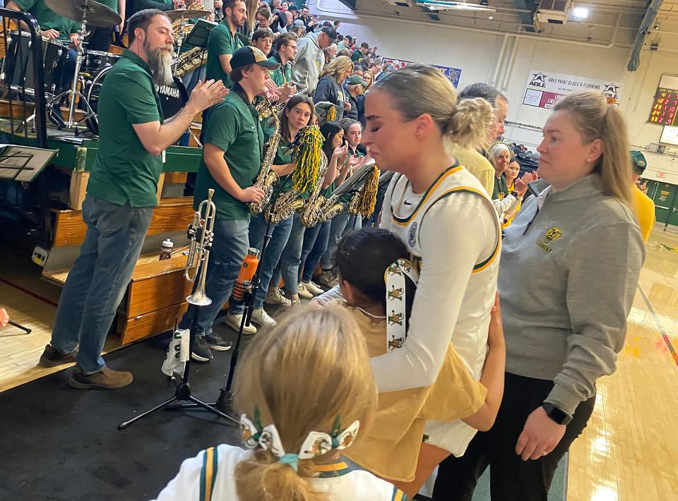 An emotional Emma Utterback gets a hug from a young fan while walking off the court for the final time at Patrick Gym on Wednesday, April 3, 2024.