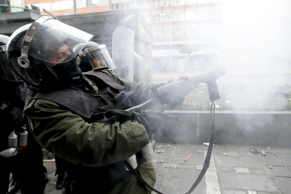 Police fires tear gas during clashes with backers of former President Evo Morales in La Paz, Bolivia, Wednesday, Nov. 13, 2019. Bolivia's new interim president Jeanine Anez faces the challenge of stabilizing the nation and organizing national elections within three months at a time of political disputes that pushed Morales to fly off to self-exile in Mexico after 14 years in power. (AP Photo/Natacha Pisarenko)