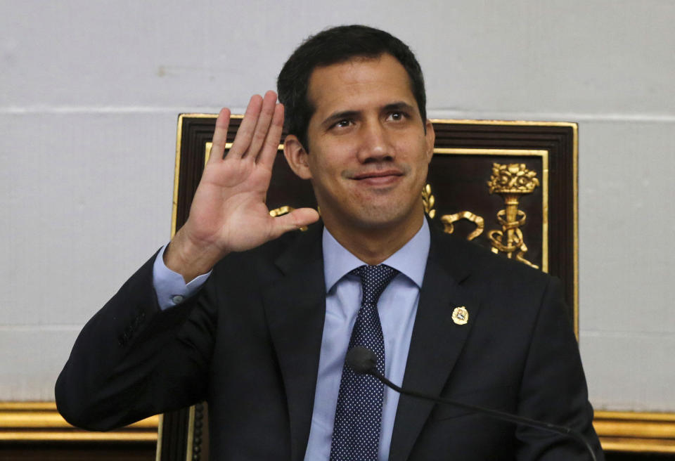 Juan Guaido, President of National Assembly and self-proclaimed interim president waves to the gallery during a session of the National Assembly in Caracas, Venezuela, Tuesday, April 2, 2019. Venezuela's chief justice on Monday asked lawmakers of the rival pro-government National Constituent Assembly to strip Guaido of his parliamentary immunity, taking a step toward prosecuting him for alleged crimes as he seeks to oust President Nicolas Maduro.(AP Photo/Fernando Llano)