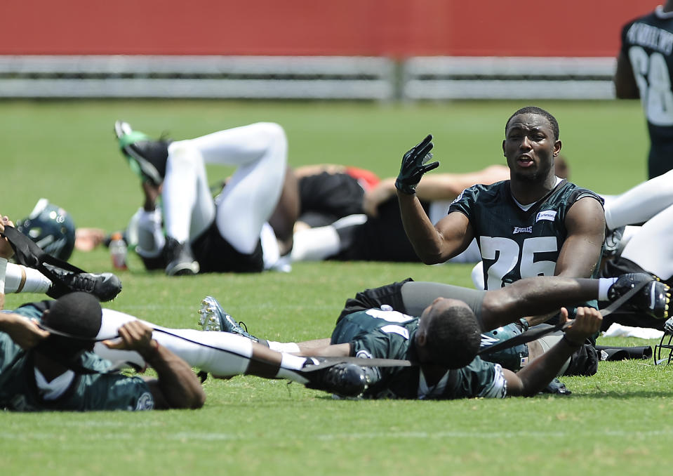 Philadelphia Eagles' LeSean McCoy, right, talks to Darren Sproles, bottom, while they stretch during NFL football training camp on Sunday, July 27, 2014, in Philadelphia. (AP Photo/Michael Perez)