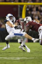 Kentucky quarterback Will Levis, front left, takes a hit by South Carolina defensive lineman Jabari Ellis (99) and defensive end Jordan Burch (3) in the first half of an NCAA college football game Saturday, Sept. 25, 2021, at Williams-Brice Stadium in Columbia, S.C. (AP Photo/Hakim Wright Sr.)