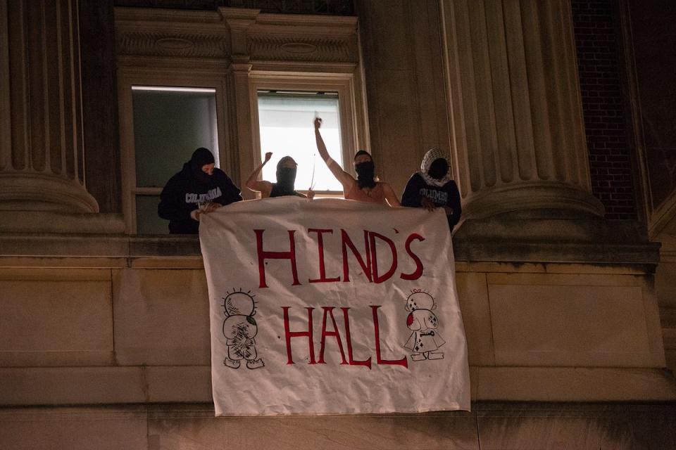 Gaza protesters hang a banner that reads ‘Hind’s Hall’ as they barricade themselves inside Columbia University’s Hamilton Hall (AP)