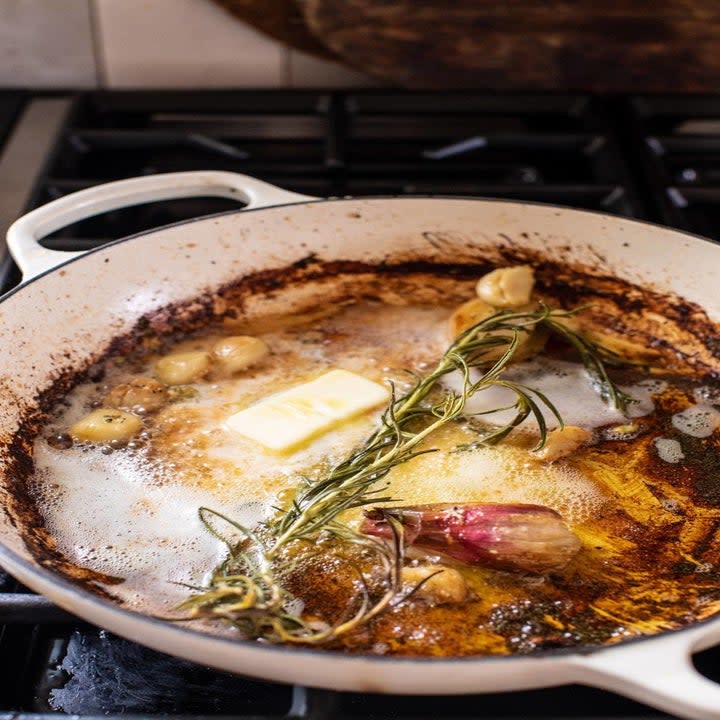 Garlic, shallot, and herbs sautéing in a skillet