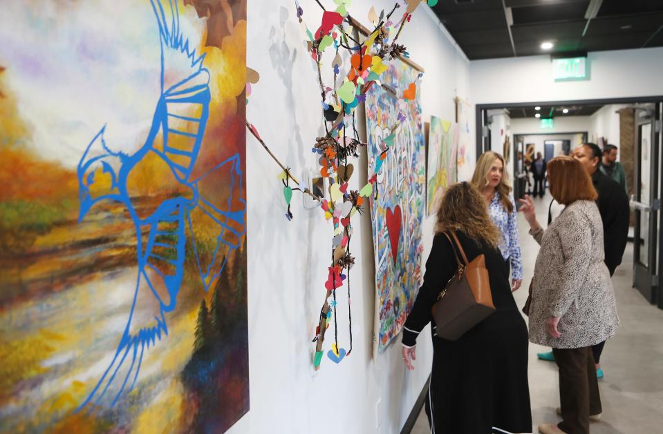 People look over some of the art work on display at the Hudson Valley InterArts grand opening in Patterson May 10, 2024 The center is designed to facilitate transformative arts experiences for people of all abilities, and it has become a beacon for creative, healing and community arts.