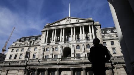 A pedestrians walks under an arch opposite the Bank of England in London March 5, 2015. REUTERS/Suzanne Plunkett