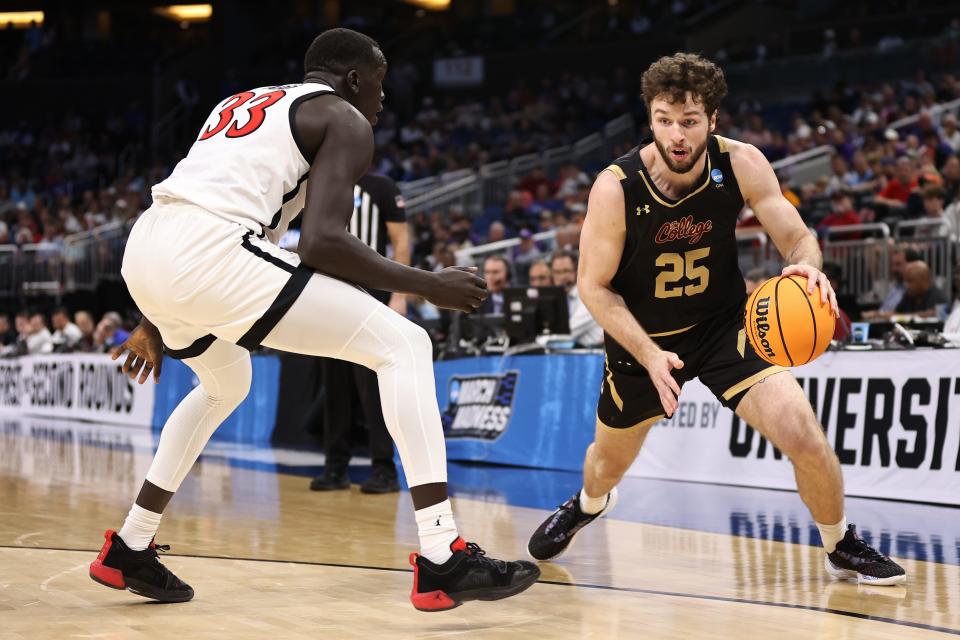 Charleston forward Ben Burnham, right, shown in action last season, led the Cougars with 23 points against URI on Sunday.