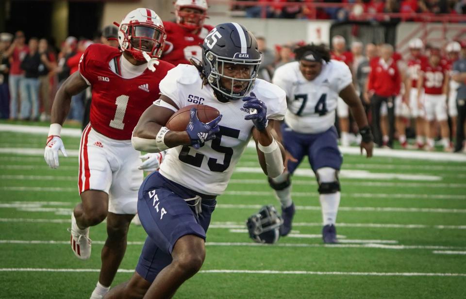 Georgia Southern's Jalen White (25) runs past Nebraska defensive back Marques Buford Jr. (1) on Sept. 10, 2022, in Lincoln, Nebraska.