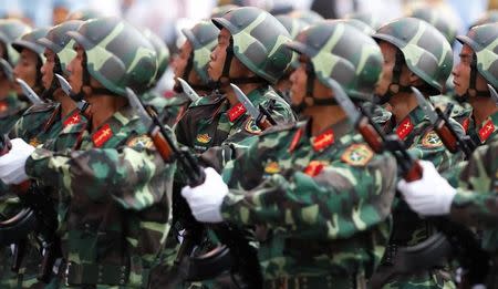 Soldiers hold rifles while marching during a celebration to mark Reunification Day in Ho Chi Minh city, Vietnam April 30, 2015. REUTERS/Kham