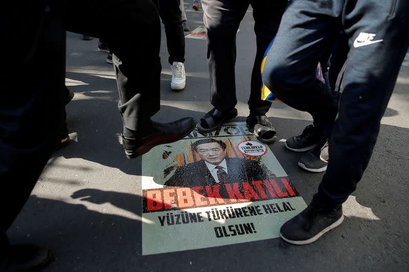 FILE PHOTO: Ethnic Uighur demonstrators step on a poster with an image of Communist Party Secretary of Xinjiang Uighur Autonomous Region Chen Quanguo during a protest against China in front of the Chinese Consulate in Istanbul