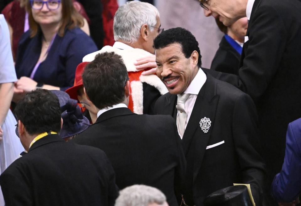 Lionel Richie shares a laugh with other guests at the ceremony (PA)