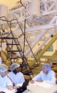 Michael Wright conducting training with the STS-107 crew at the Kennedy Space Center, April 4, 2002. The FREESTAR payload is staged in the background.