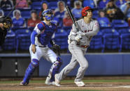 Los Angeles Angels' Shohei Ohtani watches his triple, next to Toronto Blue Jays catcher Steven Matz during the first inning of a baseball game Saturday, April 10, 2021, in Dunedin, Fla. (AP Photo/Steve Nesius)