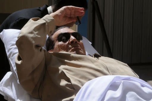 Former Egyptian president Hosni Mubarak is wheeled out of a courtroom following his verdict hearing in Cairo. Mubarak and his security chief were given life in prison over the deaths of protesters in 2011, but the acquittal of six police chiefs sparked calls for mass protest
