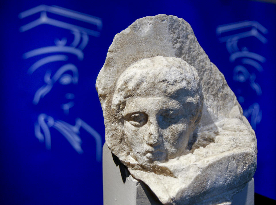 The marble head of a young man, a tiny fragment from the 2,500-year-old sculptured decoration of the Parthenon Temple on the ancient Acropolis, is displayed during a presentation to the press at the new Acropolis Museum in Athens on Wednesday, Nov. 5, 2008. The Vatican announced, Wednesday, Nov. 5, 2008 that Pope Francis has decided to send back to Greece this and other two fragments of Parthenon Sculptures that the Vatican Museums have held for two centuries. (AP Photo/Thanassis Stavrakis)