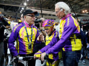 French cyclist Robert Marchand (C) prepares to start as he attempts to break his own world cycling record at the age of 105, taking part in a one-hour cycling event in the Masters + 100 category held at the Velodrome National in Montigny-les-Bretonneux, southwest of Paris, France, January 4, 2017. REUTERS/Jacky Naegelen