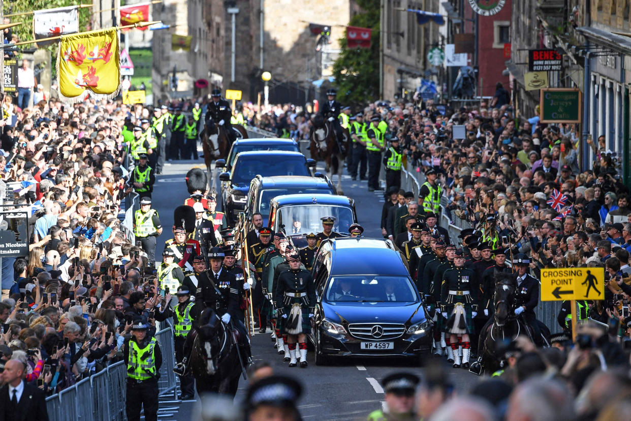 Image: Members of the public gather to watch the procession of Queen Elizabeth II's coffin, from the Palace of Holyroodhouse to St Giles Cathedral, on the Royal Mile on Sept. 12, 2022, where Queen Elizabeth II will lie at rest. (Andy Bucnanan / AFP - Getty Images)