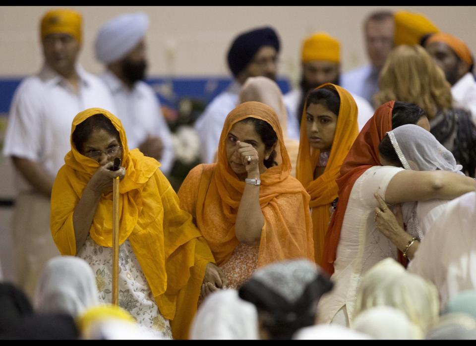Mourners attend the funeral and memorial service for the six victims of the Sikh temple of Wisconsin mass shooting in Oak Creek, Wis., Friday, Aug 10, 2012. The public service was held in the Oak Creek High School. Three other people were wounded in the shooting last Sunday at the temple. Wade Michael Page, 40, killed five men and one woman, and injured two other men. Authorities say Page then ambushed the first police officer who responded, shooting him nine times and leaving him in critical condition. A second officer then shot Page in the stomach, and Page took his own life with a shot to the head. (AP Photo/Jeffrey Phelps)