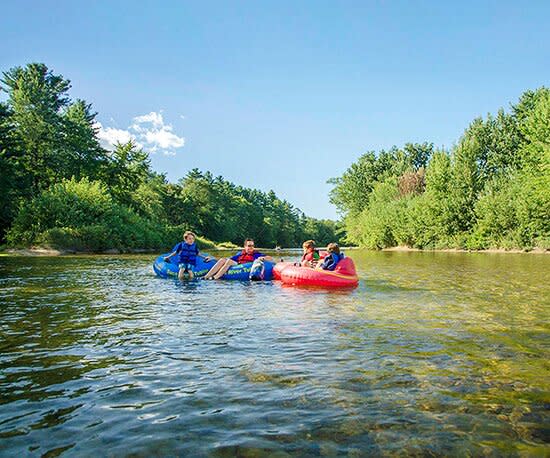 4 people in tubes on river