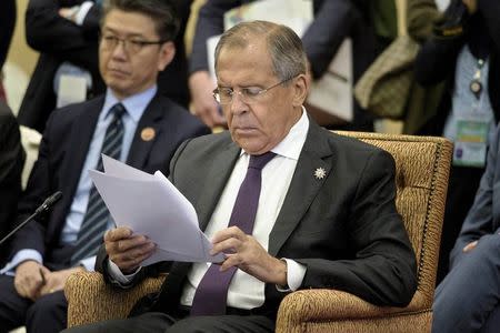 Russia's Foreign Minister Sergei Lavrov looks over a paper during the 22nd Association of Southeast Asian Nations (ASEAN) Regional Forum session at the Putra World Trade Center in Kuala Lumpur, Malaysia, August 6, 2015. REUTERS/Brendan Smialowski/Pool