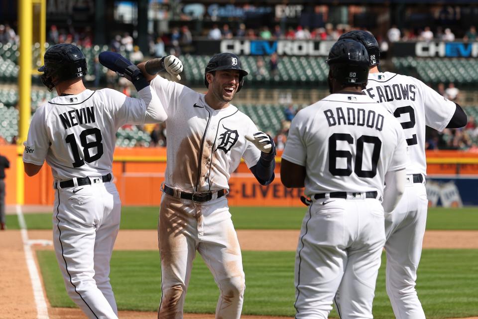 Tigers third baseman Matt Vierling, center, celebrates his grand slam home run with Tyler Nevin, Akil Baddoo and Parker Meadows in the eighth inning of the Tigers' 8-2 win over the Reds on Thursday, Sept. 14, 2023, at Comerica Park.