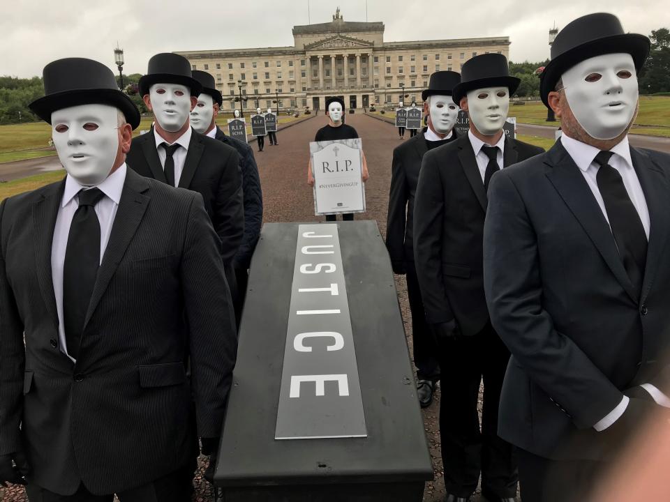 Victims hold a staged funeral procession at Stormont in protest at Government plans over legacy in Northern Ireland (Jonathan McCambridge/PA)
