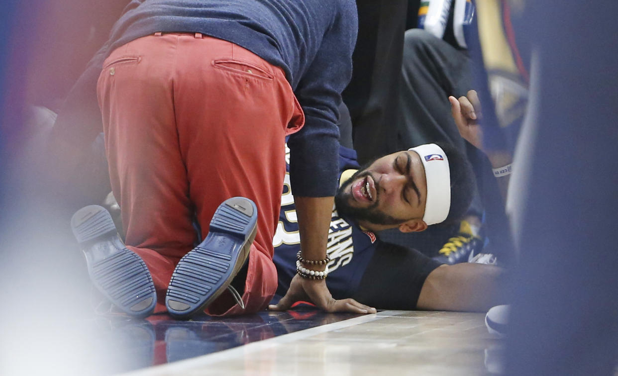 New Orleans Pelicans forward Anthony Davis lies on the court after being injured in the second half. (AP Photo/Rick Bowmer)