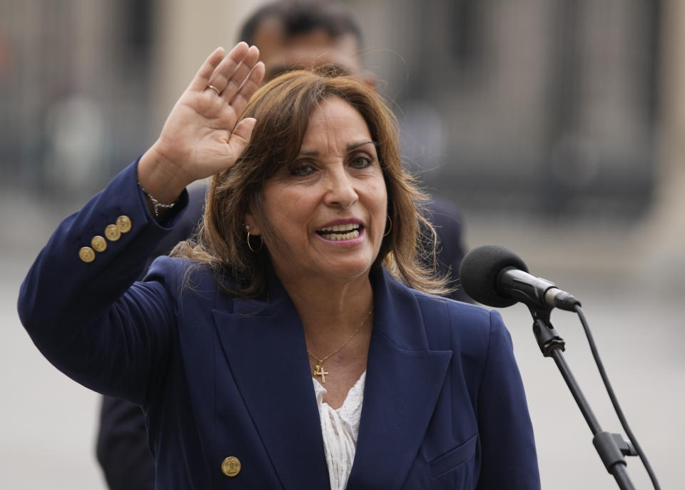 Peru's new President Dina Boluarte waves after making a statement at the government palace in Lima, Peru, Thursday, Dec. 8, 2022. Peru's Congress voted to remove President Pedro Castillo from office Wednesday and replace him with the vice president, Boluarte, shortly after Castillo tried to dissolve the legislature ahead of a scheduled vote to remove him. (AP Photo/Fernando Vergara)