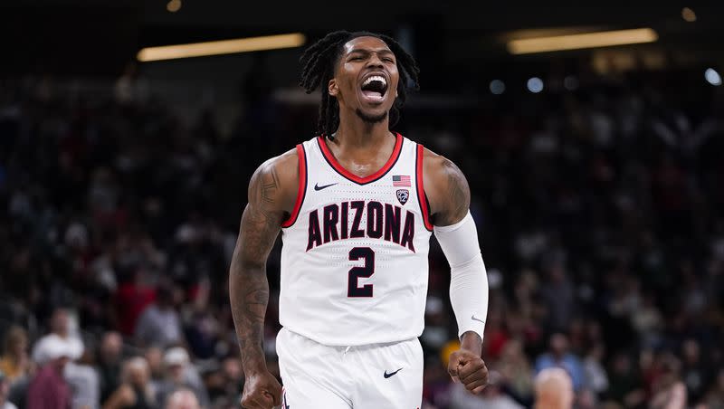 Arizona guard Caleb Love reacts after making a buzzer-beater 3-point basket to end the first half of an NCAA college basketball game against Michigan State, Thursday, Nov. 23, 2023, in Palm Desert, Calif.