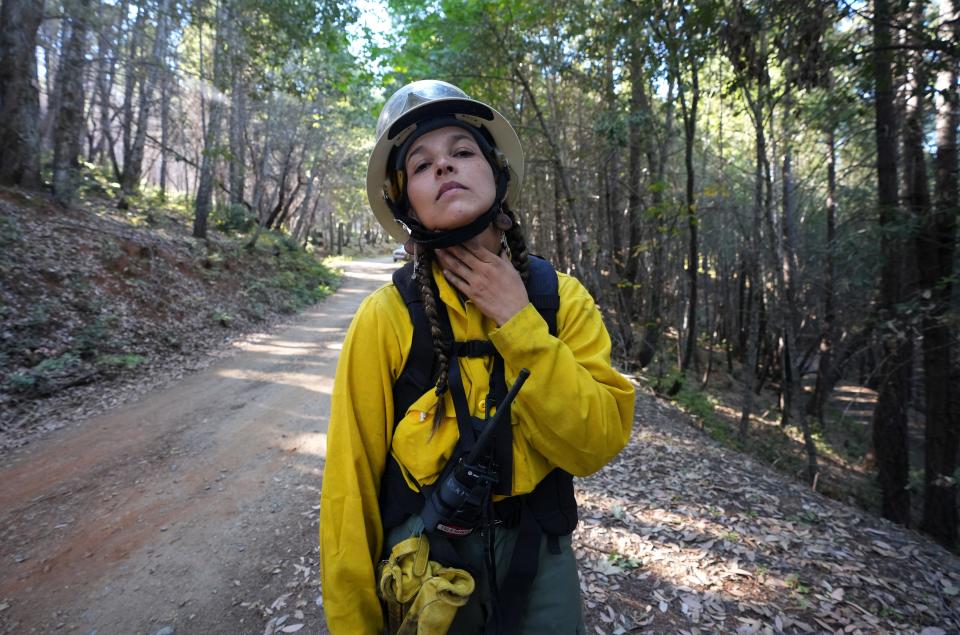 Chanel Keller of Esselen tribal heritage prepares for a controlled burn around Karuk ancestral territory, which includes land owned by the U.S. Forest Service and private landowners on Monday, Oct. 3, 2022, as part of a Indigenous Women-In-Fire Training Exchange program.