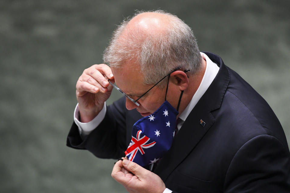 Australian Prime Minister Scott Morrison removes his face mask during House of Representatives Question Time at Parliament House in Canberra on Wednesday. Source: AAP