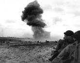 Enemy bombs hit the beach while American troops progress after landing in Normandy, France in June 1944. (Photo from Photo12/UIG via Getty Images)