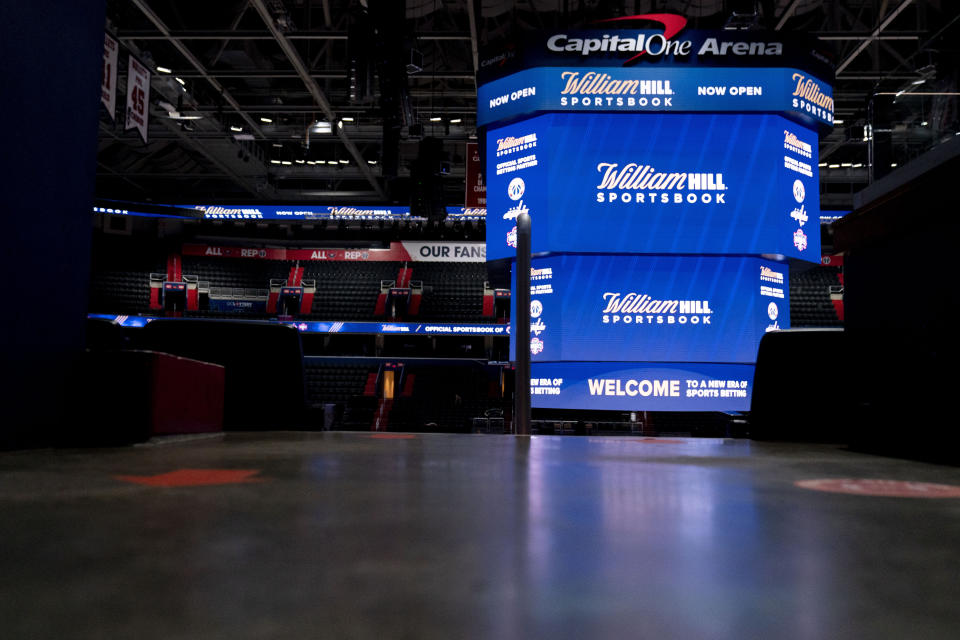 Screens display the William Hill Sportsbook logo at Monumental Sports & Entertainment's Capital One Arena in Washington, Wednesday, May 26, 2021. The first full-service sportsbook at a major four North American pro sports venue in the United States opens its doors. (AP Photo/Andrew Harnik)