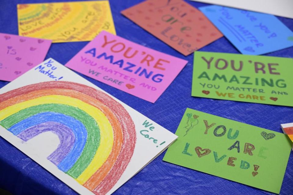 Disney cast members write messages on cards to be given to children dealing with LGBTQ issues, while participating in an employee walkout of Walt Disney World, Tuesday, March 22, 2022, in Orlando, Fla. (AP Photo/Phelan M. Ebenhack)