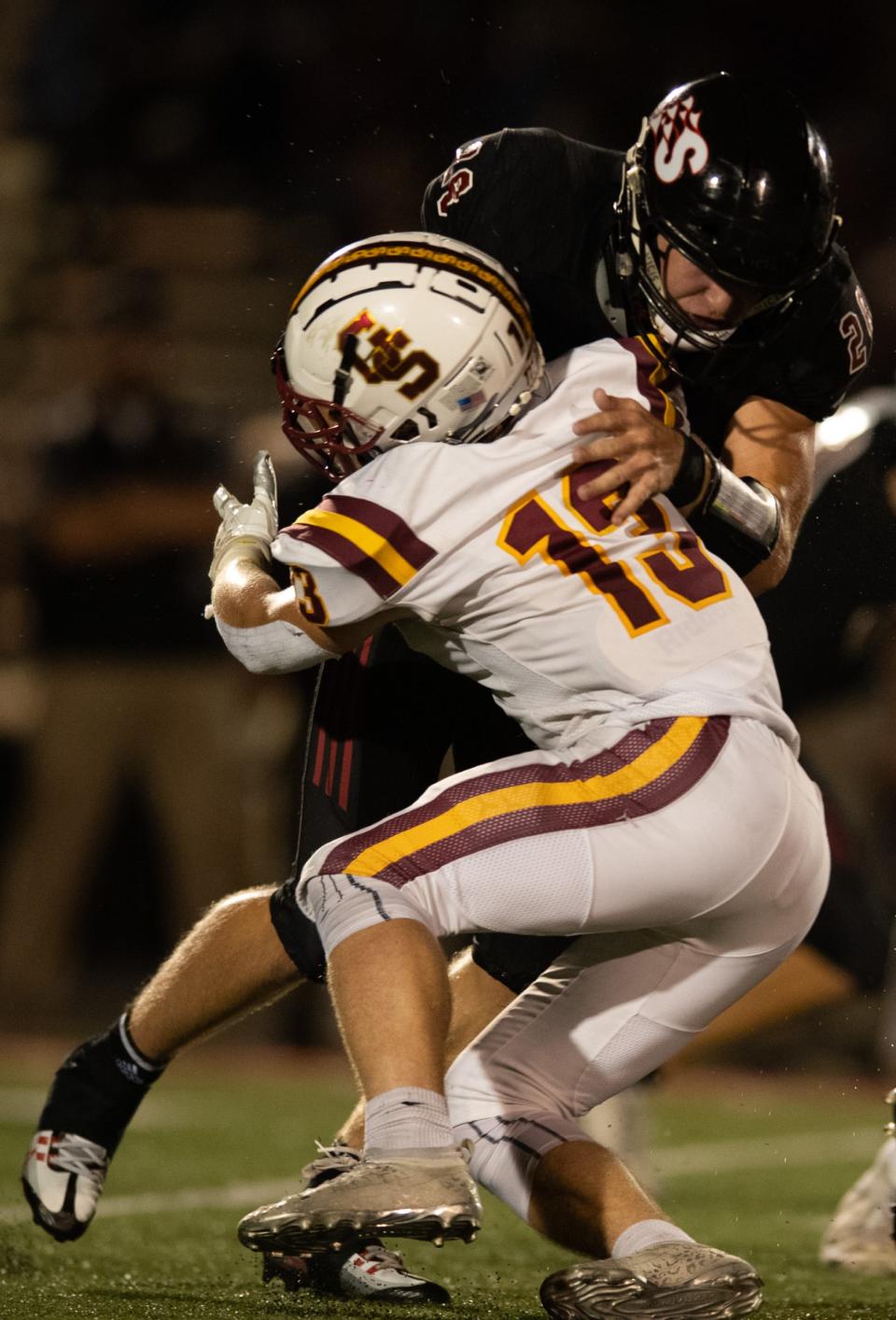 Southridge's Reid Schroeder (28) is tackled by Gibson Southern’s Beau Rose (13) as the Southridge Raiders play the Gibson Southern Titans at Southridge High School in Huntingburg, Ind., Friday evening, Sept. 16, 2022. 