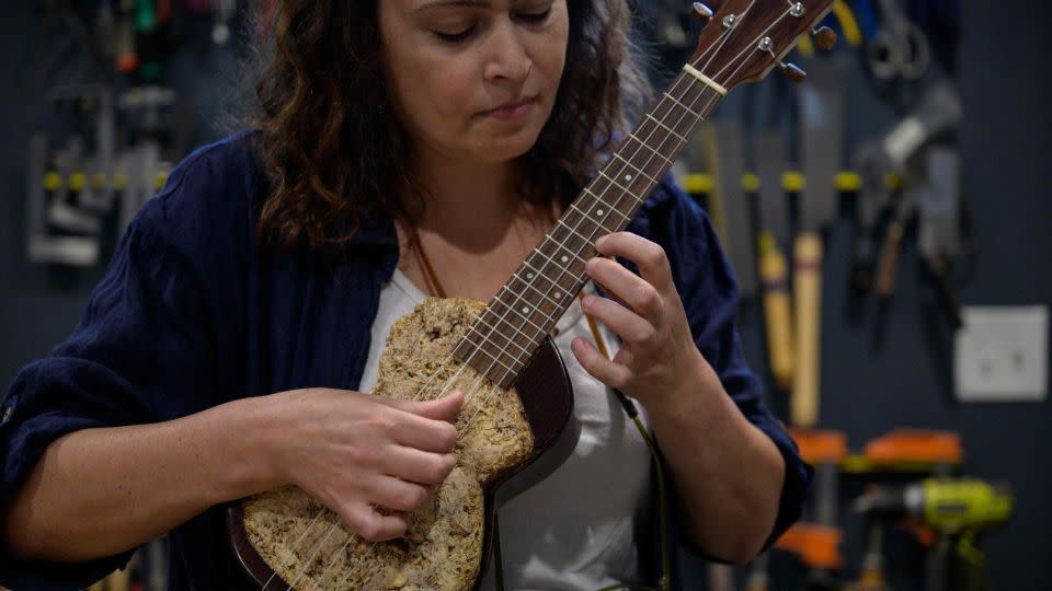 Rachel Rosenkrantz playing a mycelium ukulele . - Angela Weiss/AFP/Getty Images