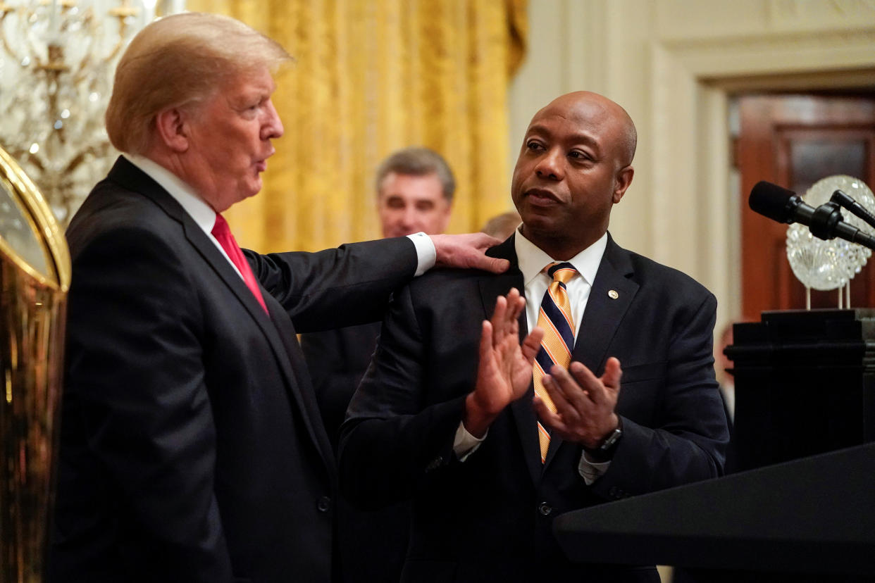 U.S. President Donald Trump greets Senator Tim Scott (R-SC) as he welcomes the 2018 College Football Playoff National Champion Clemson Tigers at the White House in Washington, U.S., January 14, 2019. REUTERS/Joshua Roberts