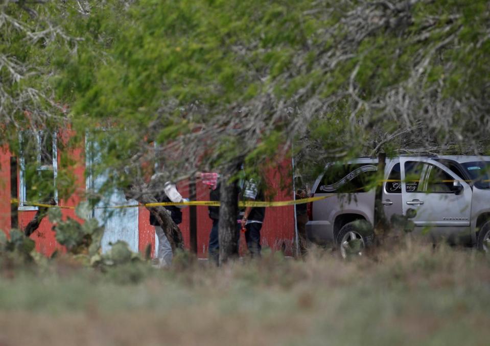 Forensic technicians and authorities work next to a funeral parlor vehicle at the scene where the bodies of two of four kidnapped American citizens were found (REUTERS)